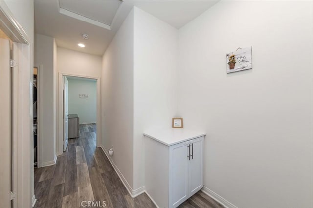 corridor with dark hardwood / wood-style flooring