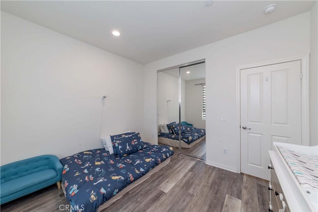 bedroom featuring hardwood / wood-style flooring and a closet