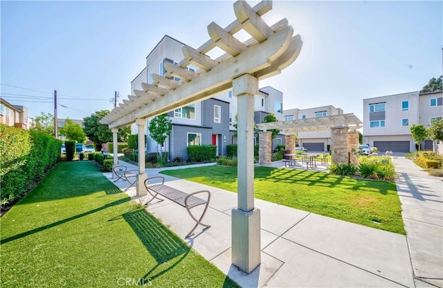 surrounding community featuring a lawn and a pergola