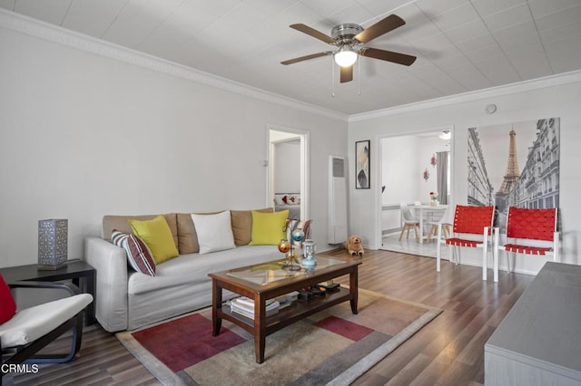 living room featuring ceiling fan, dark hardwood / wood-style flooring, and crown molding