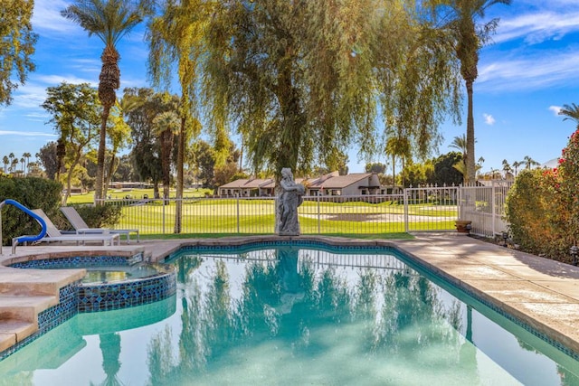 view of swimming pool with an in ground hot tub and a yard