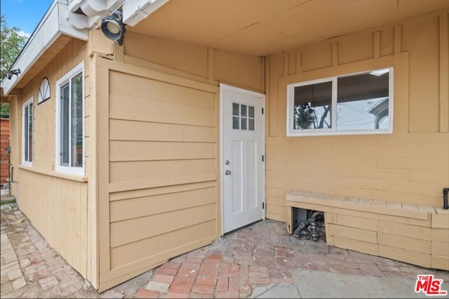 property entrance featuring a patio area