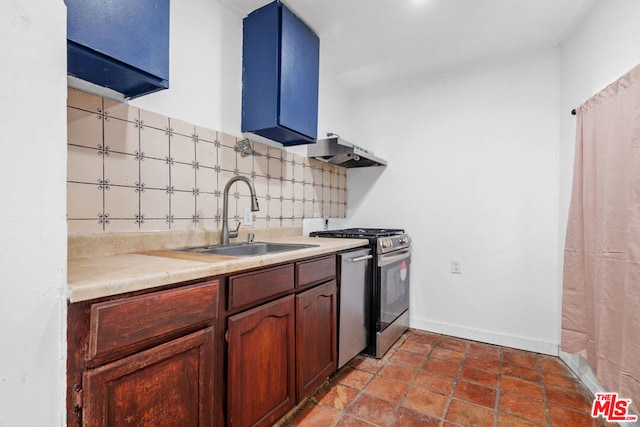 kitchen featuring extractor fan, backsplash, stainless steel range with gas cooktop, and sink