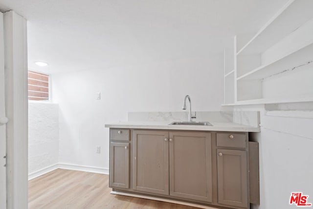 interior space with hardwood / wood-style flooring and sink