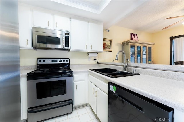 kitchen featuring white cabinets, appliances with stainless steel finishes, sink, and light tile patterned flooring