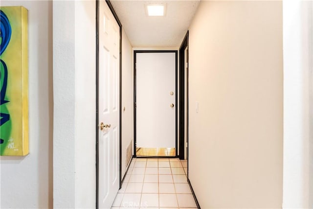 hall featuring light tile patterned flooring