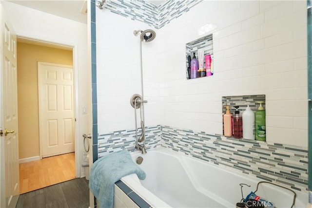 bathroom featuring shower / bathtub combination and hardwood / wood-style flooring