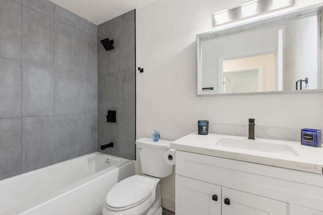 full bathroom featuring vanity, tiled shower / bath, and toilet