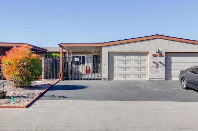 ranch-style house featuring a garage and ceiling fan