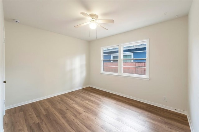 unfurnished room featuring ceiling fan and hardwood / wood-style flooring