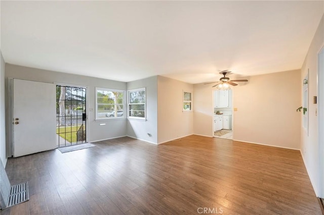 unfurnished room featuring ceiling fan and hardwood / wood-style floors