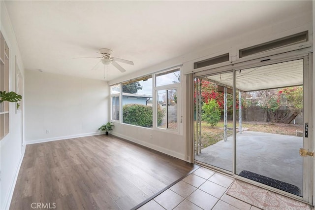 doorway to outside with ceiling fan and light wood-type flooring