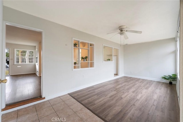 unfurnished room with ceiling fan and light hardwood / wood-style floors