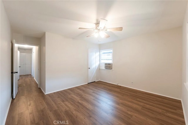 unfurnished room featuring ceiling fan, cooling unit, and dark hardwood / wood-style floors