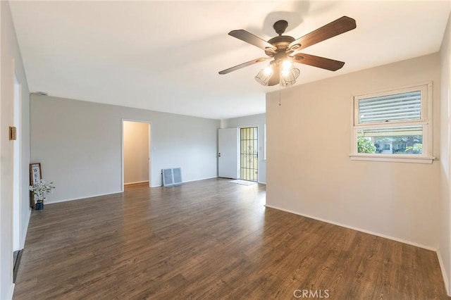 unfurnished room featuring dark wood-type flooring and ceiling fan