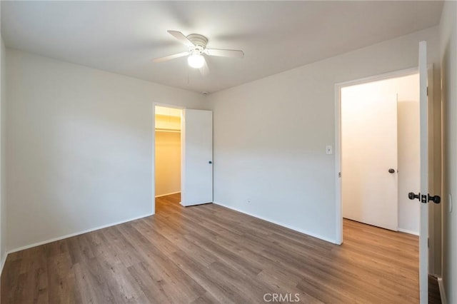 spare room featuring ceiling fan and light hardwood / wood-style flooring