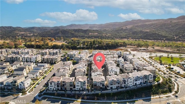 birds eye view of property featuring a mountain view