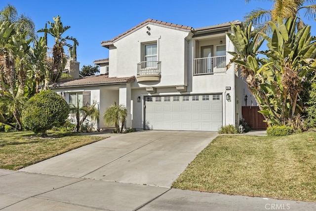 mediterranean / spanish house with a front yard, a balcony, and a garage