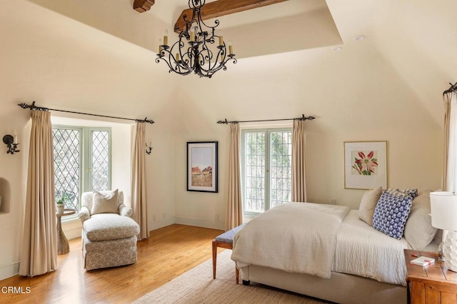 bedroom with hardwood / wood-style floors and a chandelier