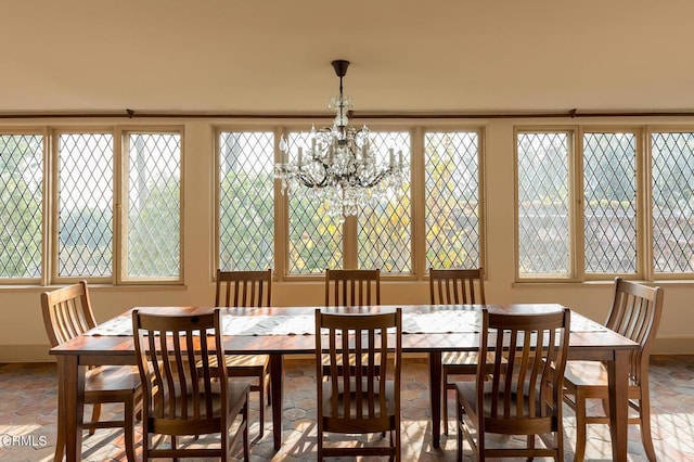 dining area featuring a wealth of natural light and a chandelier