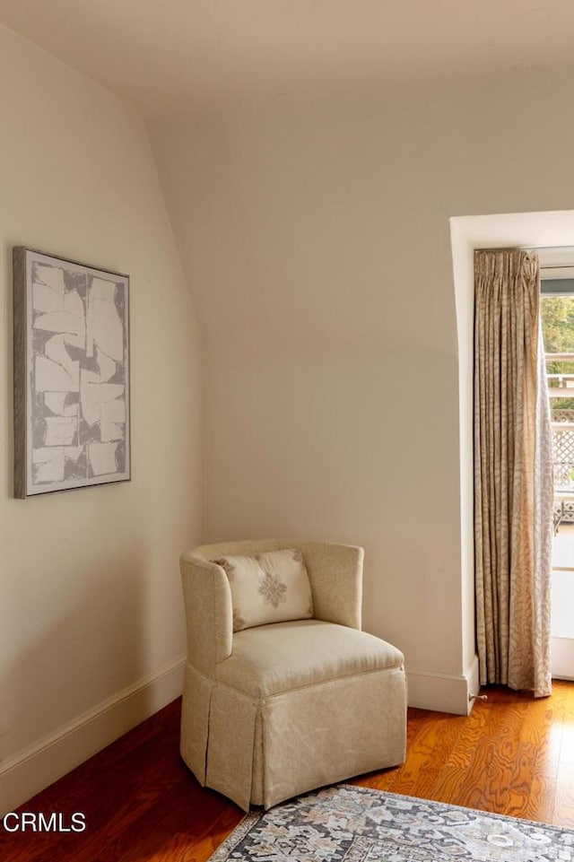 sitting room featuring lofted ceiling and wood-type flooring