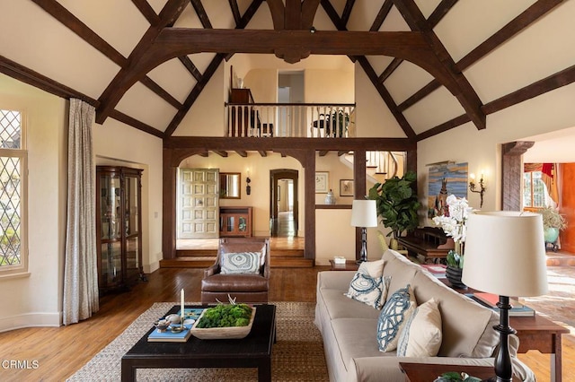 living room with high vaulted ceiling and hardwood / wood-style flooring