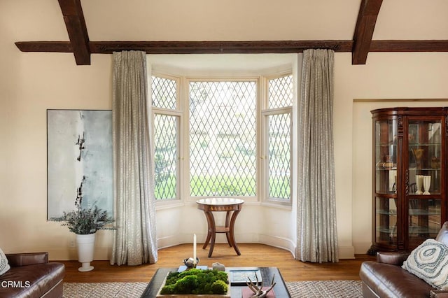 living area with hardwood / wood-style floors and beamed ceiling