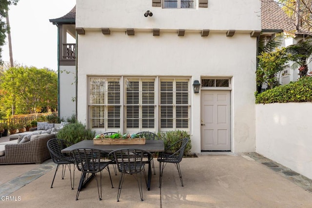 rear view of property with a patio area and outdoor lounge area