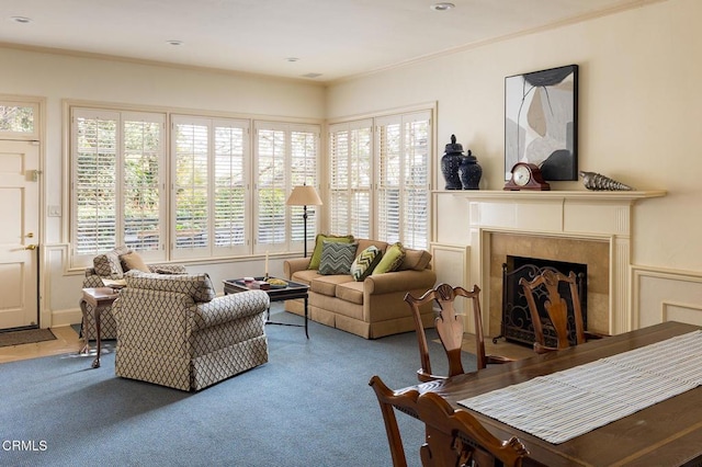 sitting room featuring a wealth of natural light, carpet flooring, and a tile fireplace