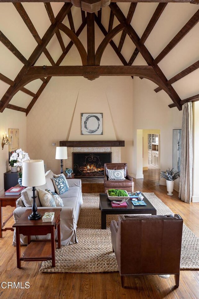 790 Huntington Cir, Pasadena, CA 91106 - living room featuring high vaulted ceiling, a fireplace, beamed ceiling, baseboards, and wood finished floors