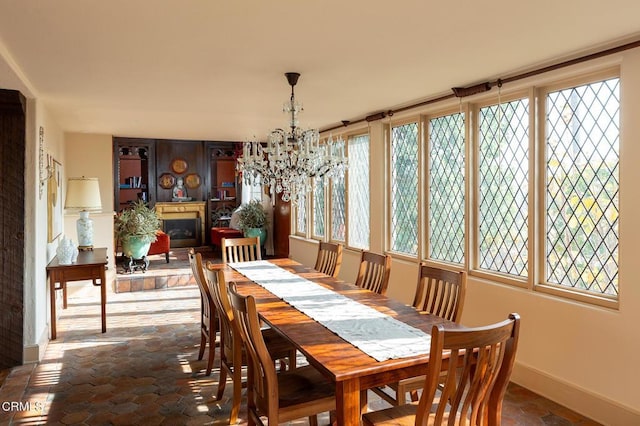 790 Huntington Cir, Pasadena, CA 91106 - dining space with healthy amount of natural light, baseboards, a chandelier, and a fireplace