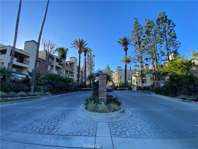 view of road with a residential view and curbs