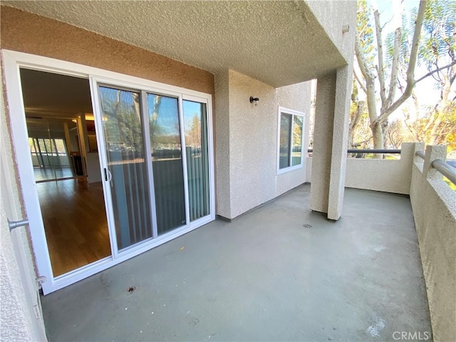 view of patio featuring a balcony