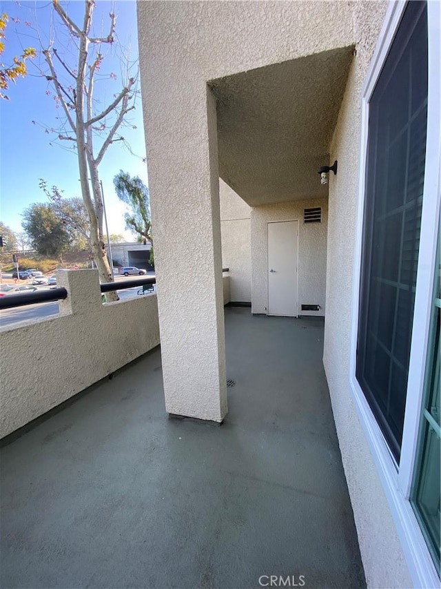 view of patio featuring a balcony