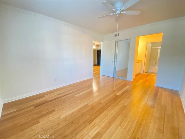 spare room featuring ornamental molding, ceiling fan, and light wood-type flooring