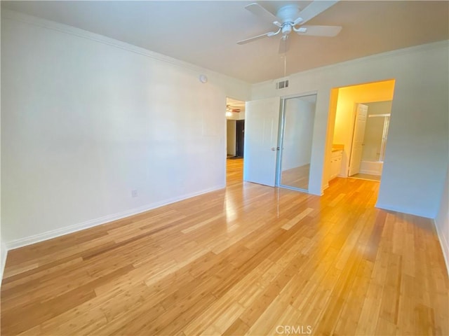 unfurnished bedroom with light wood-style floors, a closet, visible vents, and crown molding