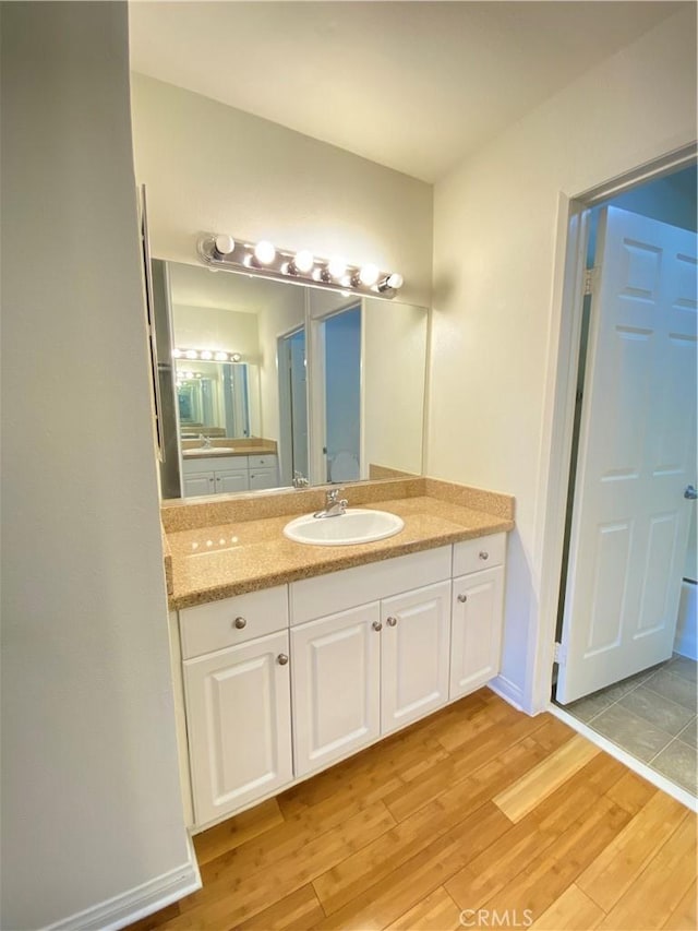 bathroom with vanity and hardwood / wood-style floors