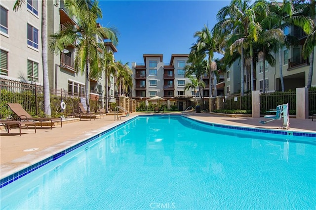 pool featuring a patio area and fence