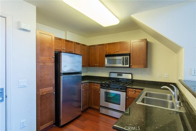 kitchen with dark wood-type flooring, appliances with stainless steel finishes, and sink