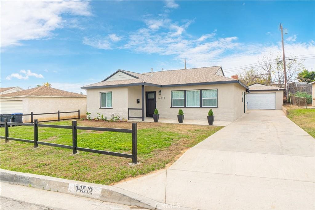 ranch-style house featuring a garage and a front yard