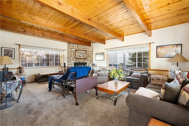 living room featuring beam ceiling, carpet, a fireplace, and wooden ceiling