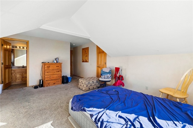 carpeted bedroom featuring sink, connected bathroom, and vaulted ceiling