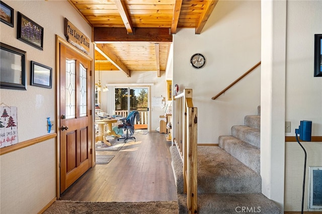 foyer entrance with wooden ceiling, dark hardwood / wood-style floors, and beamed ceiling