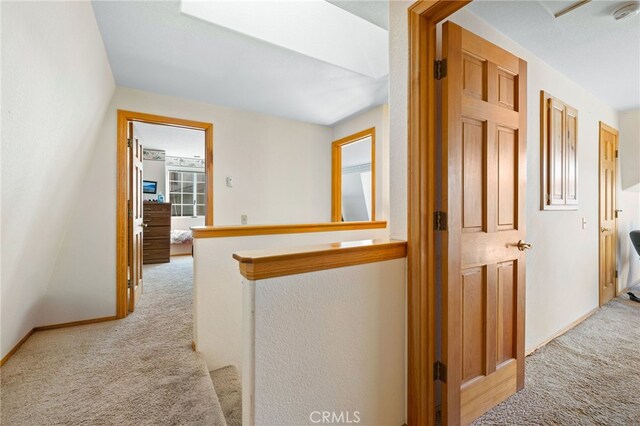 corridor with light colored carpet