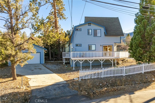 view of front of home with a garage and an outdoor structure