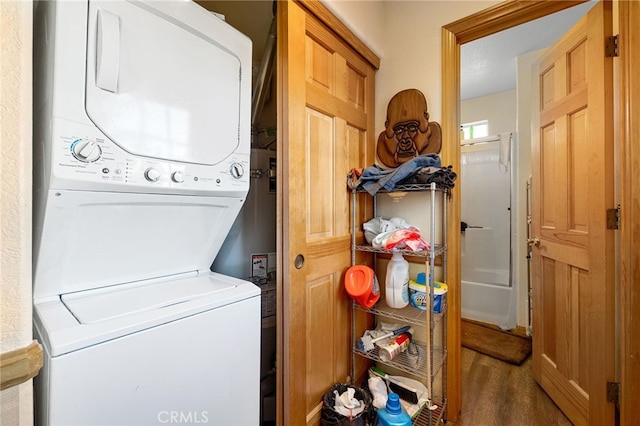 clothes washing area featuring stacked washer / dryer