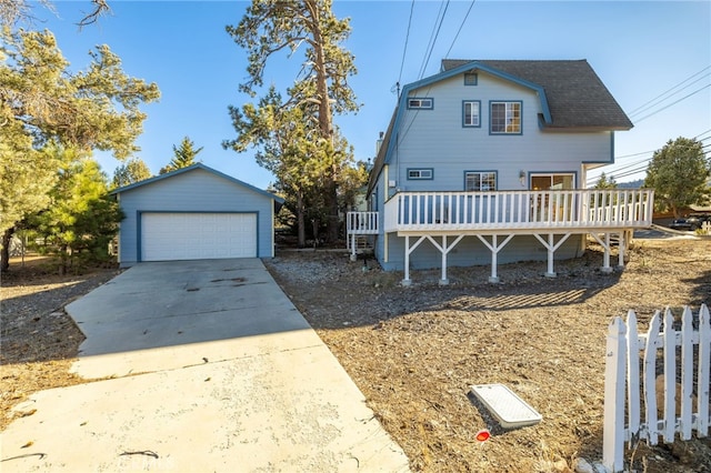 view of front facade with an outdoor structure, a wooden deck, and a garage