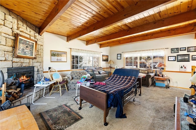 carpeted living room with wood ceiling, beam ceiling, and a stone fireplace