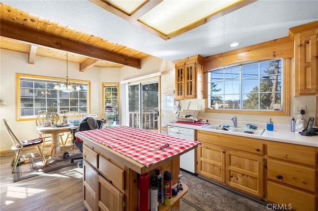 kitchen with dishwasher, a center island, beam ceiling, hanging light fixtures, and dark hardwood / wood-style flooring