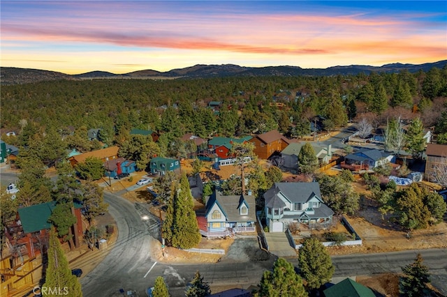 aerial view at dusk featuring a mountain view